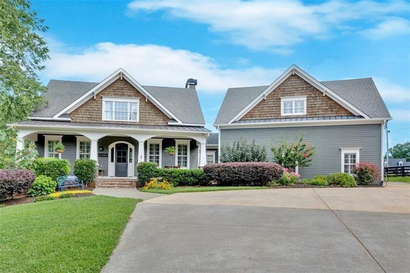 1021 Avery Road Canton, GA 30115 - Photo 3 of 70 a front view of a house with a garden