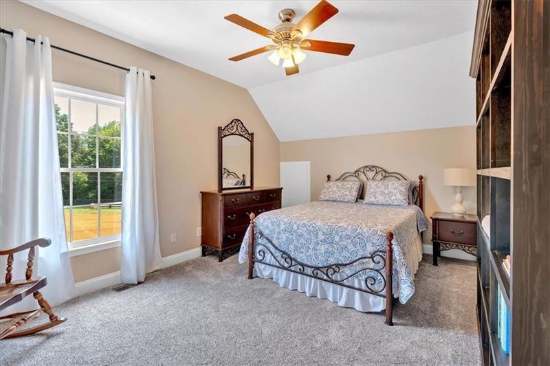 1021 Avery Road Canton, GA 30115 - Photo 36 of 70 a bedroom with a bed and a chandelier