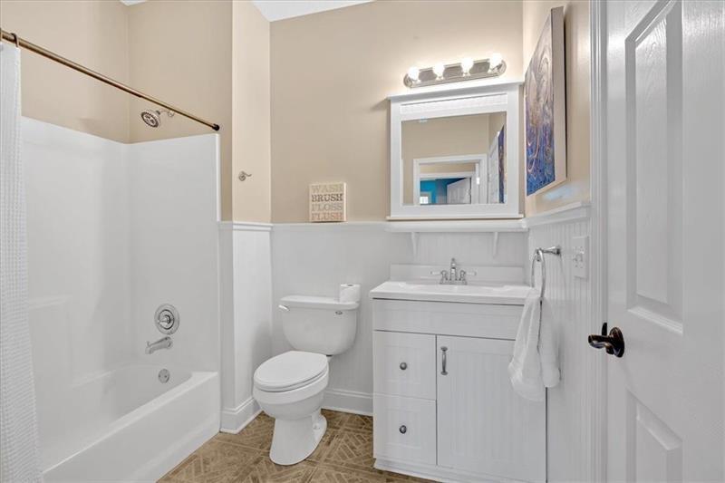 1021 Avery Road Canton, GA 30115 - Photo 40 of 70 a bathroom with a toilet sink vanity tub and mirror