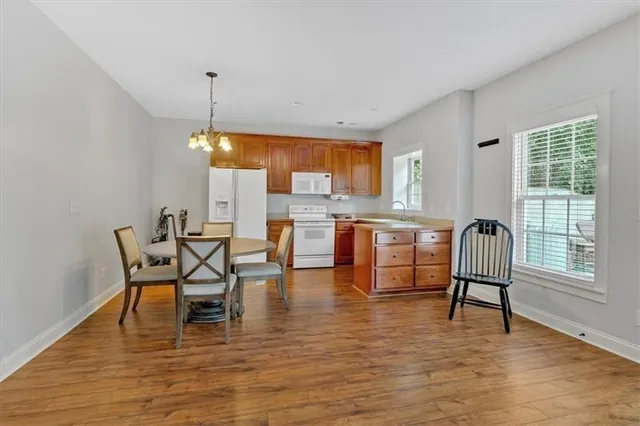 a view of a house with a yard and sitting area