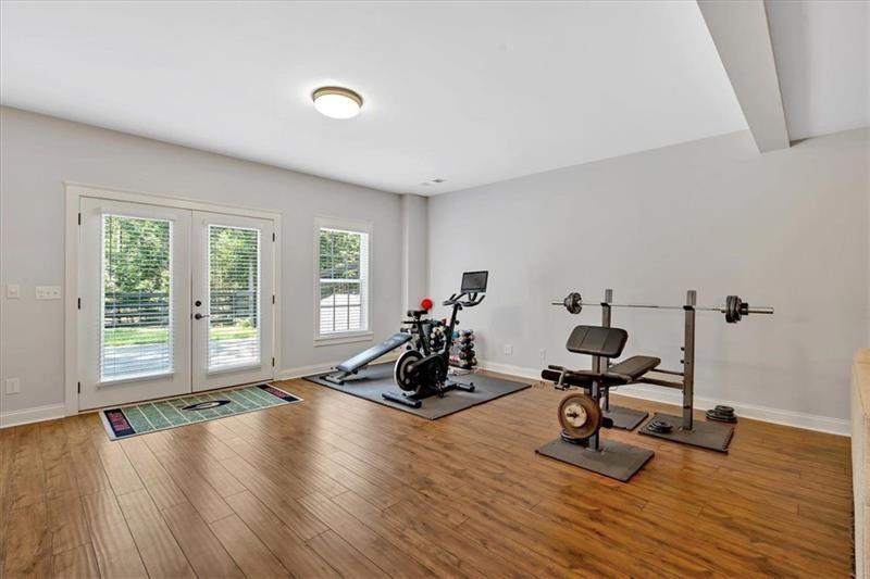 1021 Avery Road Canton, GA 30115 - Photo 45 of 70 a view of a room with gym equipment and wooden floor