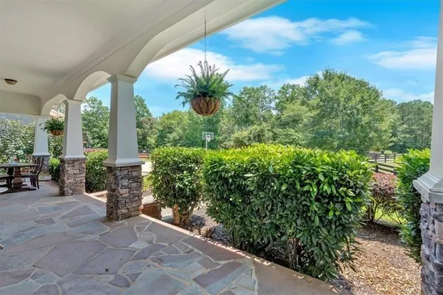 a view of staircase with wooden floor and a chandelier