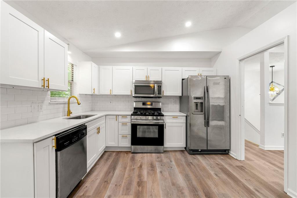 2290 Wilkins Cove Decatur, GA 30035 - Photo 6 of 21 a kitchen with stainless steel appliances granite countertop a stove a refrigerator and a sink
