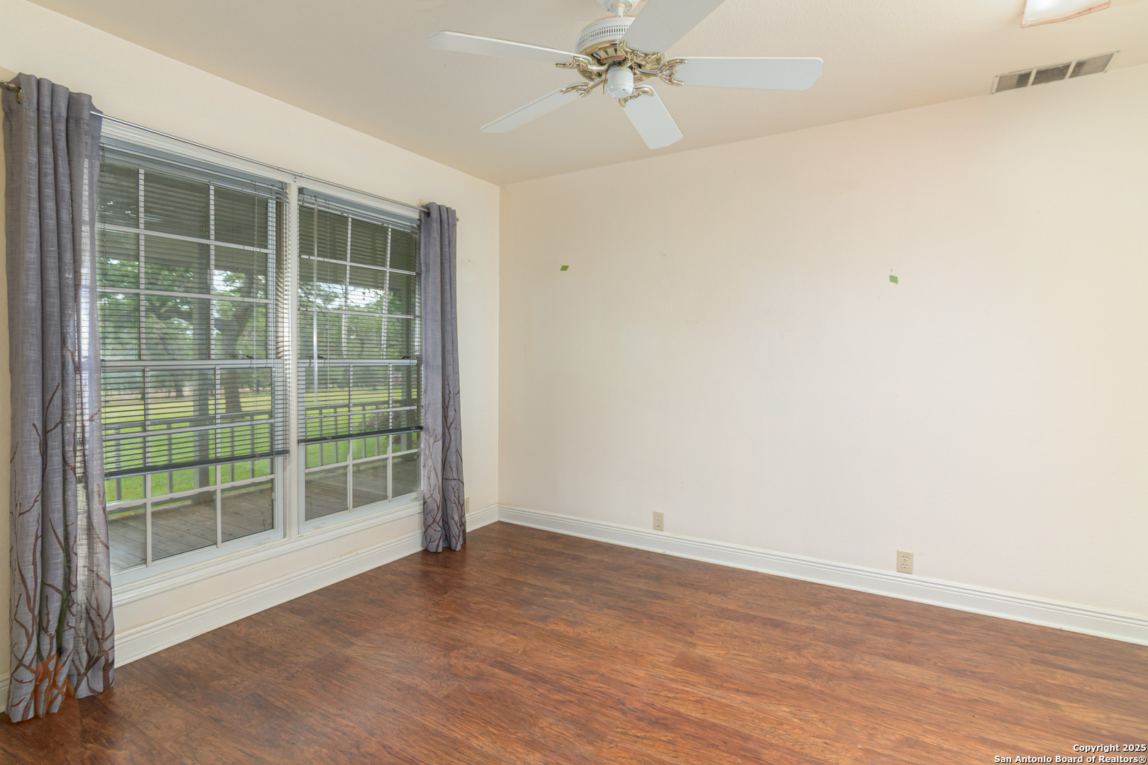 2981 Vivroux Ranch Road Seguin, TX 78155 - Photo 17 of 50 an empty room with wooden floor and windows
