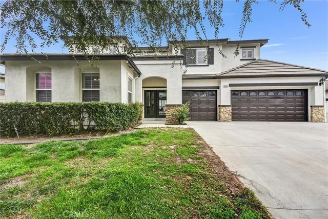 a front view of a house with a yard and garage