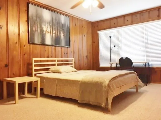 a bedroom with a bed and a window