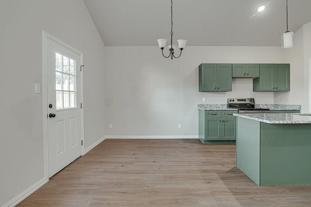 2729 Finley Street Fort Worth, TX 76111 - Photo 13 of 30 a kitchen with granite countertop a sink cabinets and stainless steel appliances
