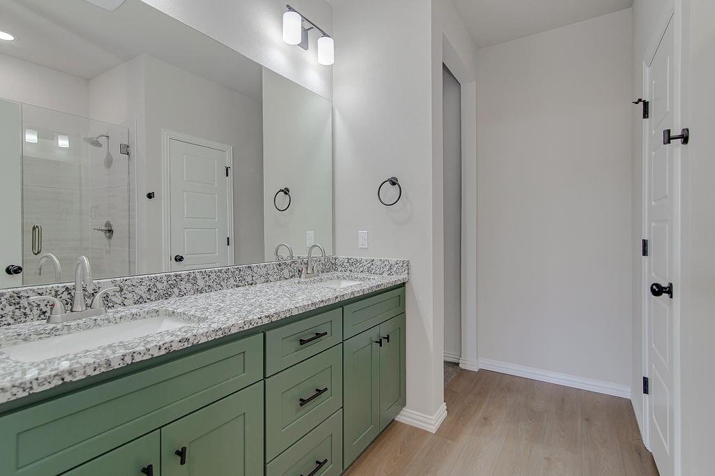 2729 Finley Street Fort Worth, TX 76111 - Photo 19 of 30 a bathroom with a granite countertop sink double and mirror