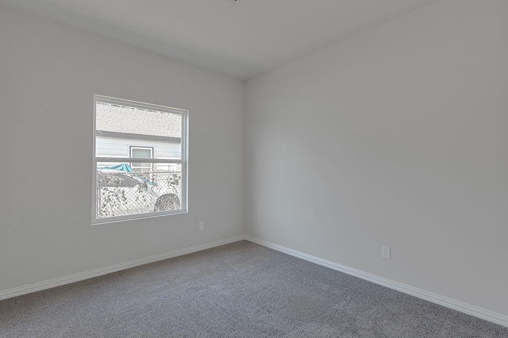 2729 Finley Street Fort Worth, TX 76111 - Photo 22 of 30 an empty room with windows
