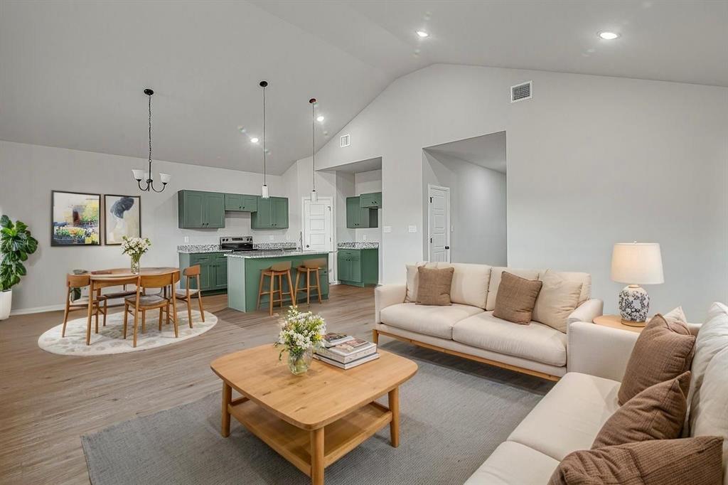 2729 Finley Street Fort Worth, TX 76111 - Photo 3 of 30 a living room with furniture kitchen view and a wooden floor