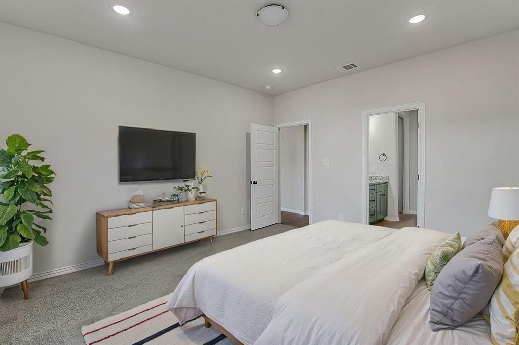2729 Finley Street Fort Worth, TX 76111 - Photo 5 of 30 a spacious bedroom with a bed and a flat screen tv