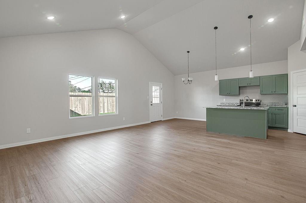 2729 Finley Street Fort Worth, TX 76111 - Photo 7 of 30 a view of kitchen with window and wooden floor