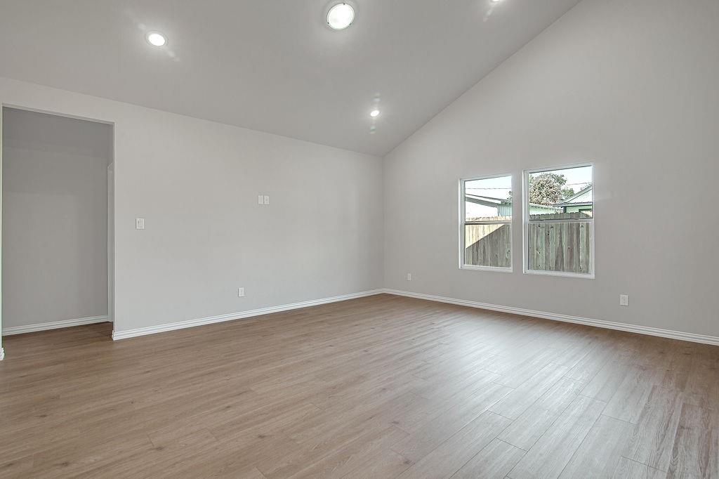 2729 Finley Street Fort Worth, TX 76111 - Photo 10 of 30 a view of an empty room with wooden floor and a window