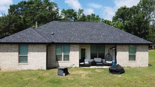 a view of a house with backyard sitting area and garden