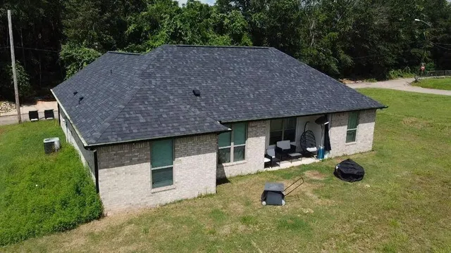 a aerial view of a house with swimming pool and sitting area
