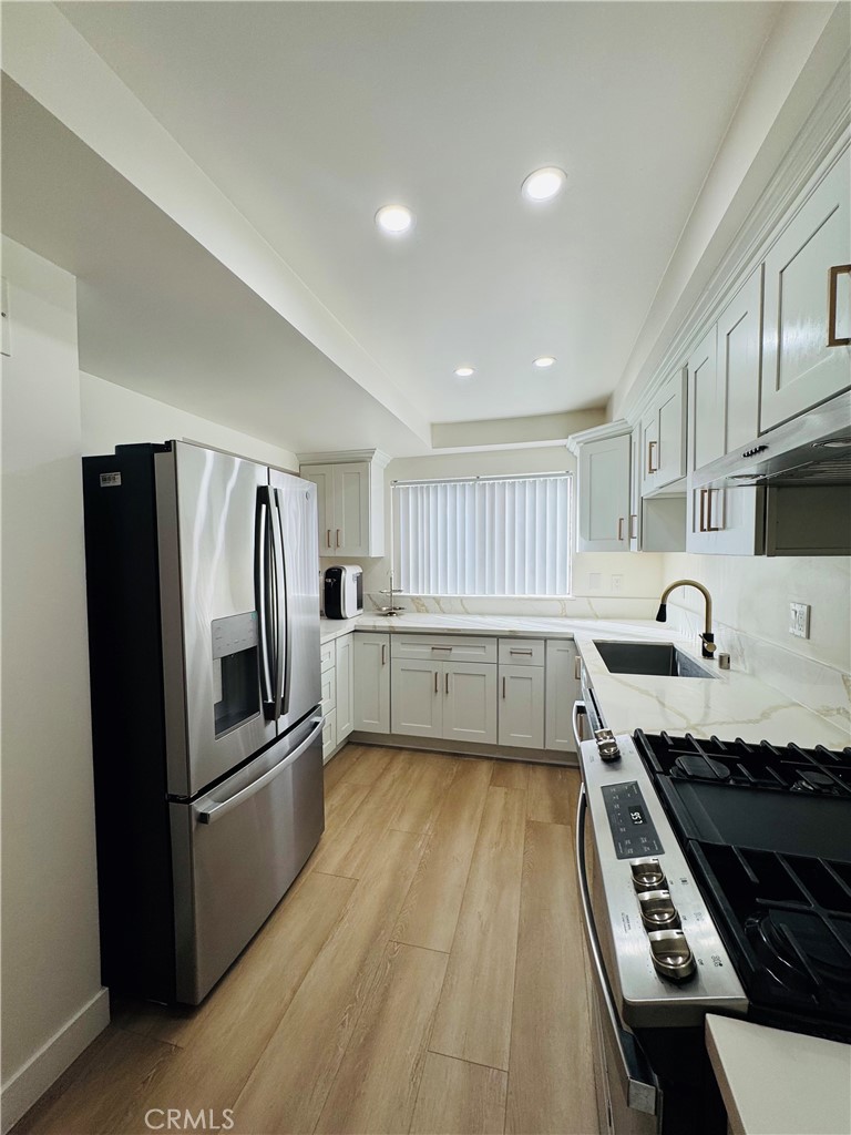 28202 Ridgepoint Court Rancho Palos Verdes, CA 90275 - Photo 14 of 33 a kitchen with granite countertop a refrigerator and a stove top oven