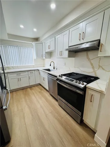 a kitchen with granite countertop a stove and a sink