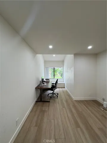 a view of a livingroom with furniture and wooden floor