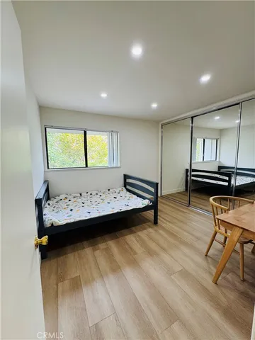 a view of a room with wooden floor and furniture