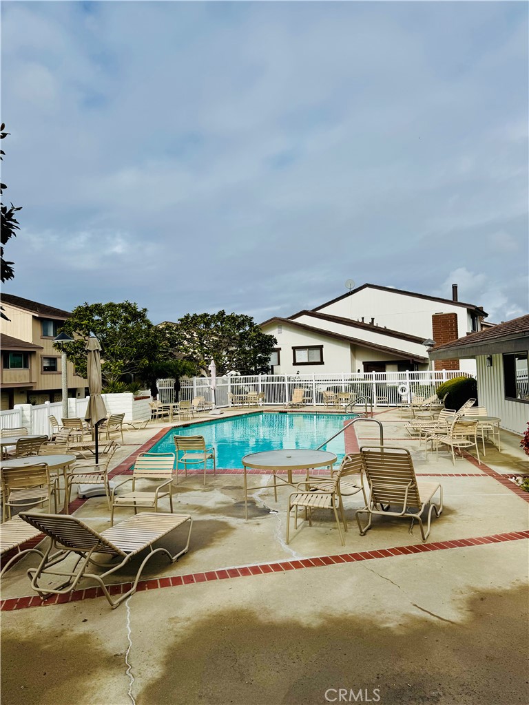 28202 Ridgepoint Court Rancho Palos Verdes, CA 90275 - Photo 29 of 33 a view of a swimming pool with lawn chairs and iron fence