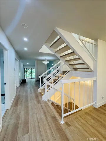 a view of a room with wooden floor and windows