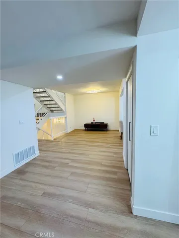 a view of a room with wooden floor