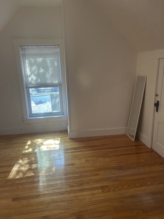 123 Mayfield Street, Unit 2 Worcester, MA 01602 - Photo 14 of 16 a view of empty room with wooden floor and fan
