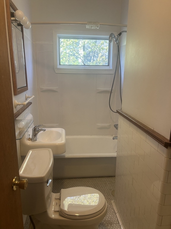 123 Mayfield Street, Unit 2 Worcester, MA 01602 - Photo 15 of 16 a white toilet sitting next to a bath tub shower