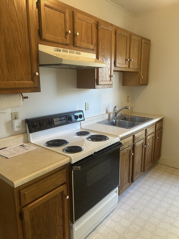 123 Mayfield Street, Unit 2 Worcester, MA 01602 - Photo 2 of 16 a kitchen with stainless steel appliances granite countertop a sink stove and microwave
