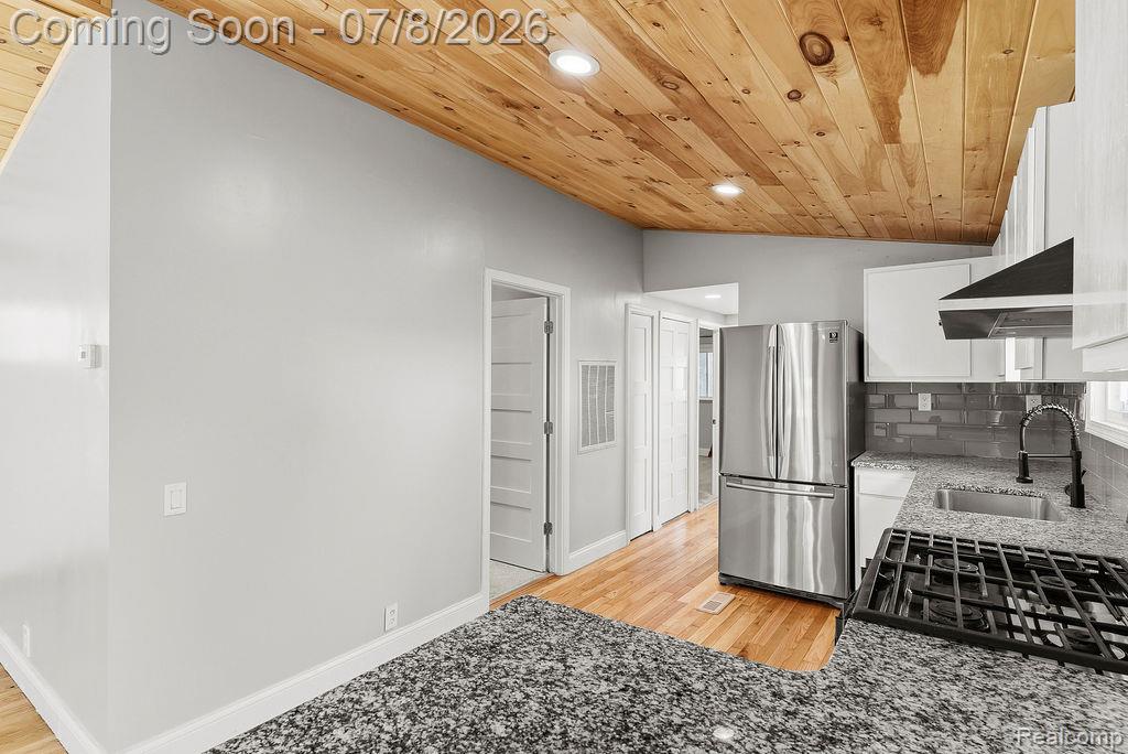 5698 McGrandy Road Bridgeport, MI 48722 - Photo 14 of 26 Kitchen area featuring a wood-panel vaulted ceiling with recessed lighting