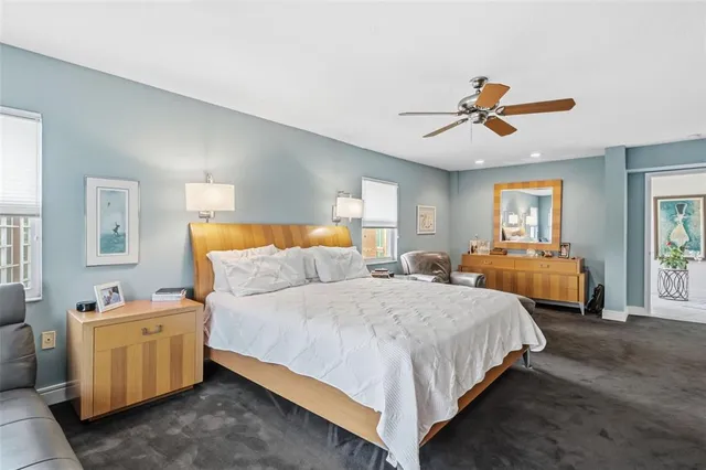 a spacious bathroom with a granite countertop sink mirror and shower