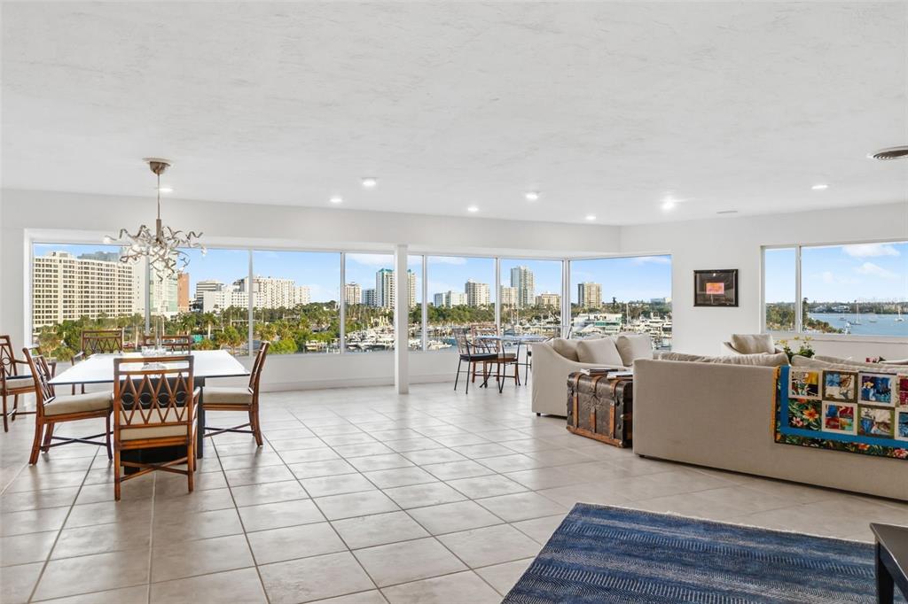 660 Golden Gate Point, Unit 61 Sarasota, FL 34236 - Photo 16 of 44 a living room with lots of furniture and kitchen view