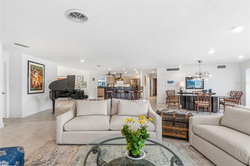 660 Golden Gate Point, Unit 61 Sarasota, FL 34236 - Photo 23 of 44 a living room with furniture and a chandelier
