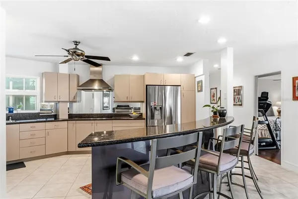 a kitchen with stainless steel appliances granite countertop a sink and cabinets with wooden floor