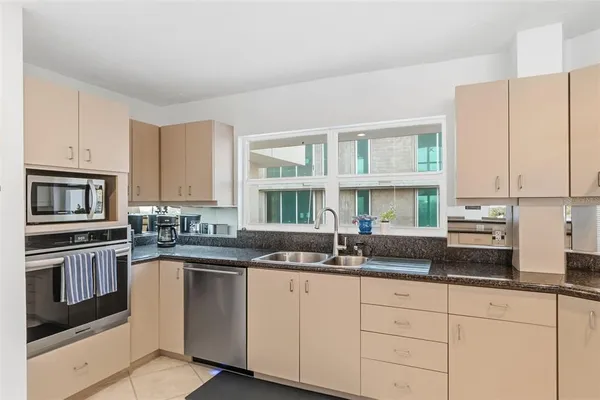 a kitchen with stainless steel appliances granite countertop a refrigerator and a sink