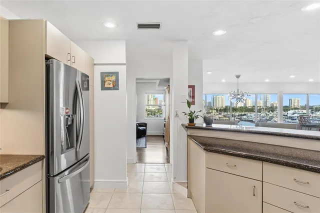 a kitchen with granite countertop stainless steel appliances a sink and cabinets