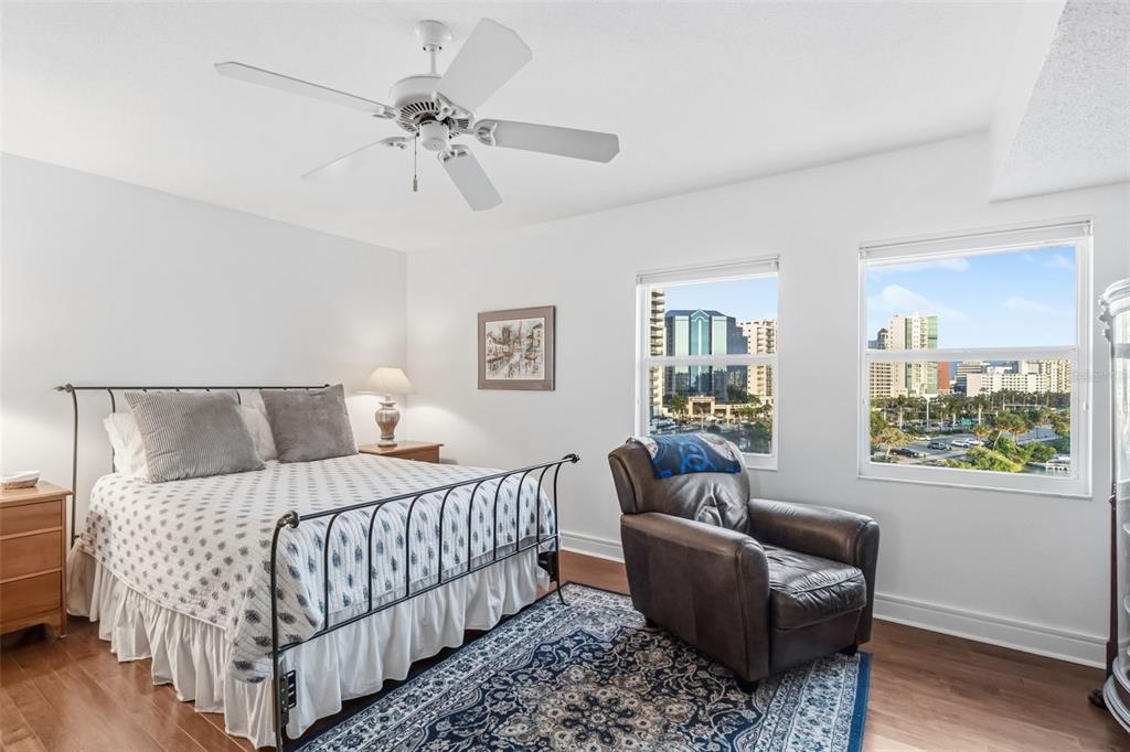 660 Golden Gate Point, Unit 61 Sarasota, FL 34236 - Photo 34 of 44 a bedroom with a bed and a chandelier