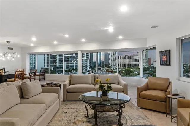 a living room with stainless steel appliances granite countertop furniture and a counter top