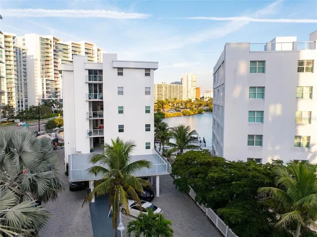 a view of balcony with potted plants and a building