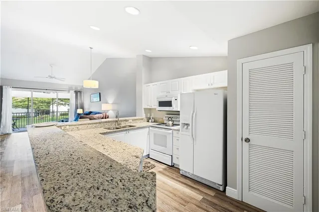 a kitchen with refrigerator and cabinets