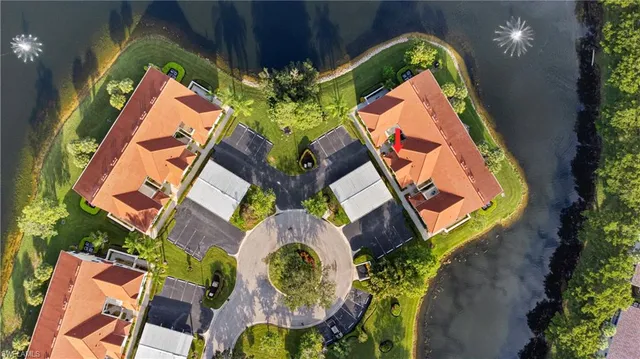 an aerial view of residential houses with outdoor space and swimming pool