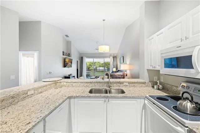 a kitchen with sink stove and cabinets