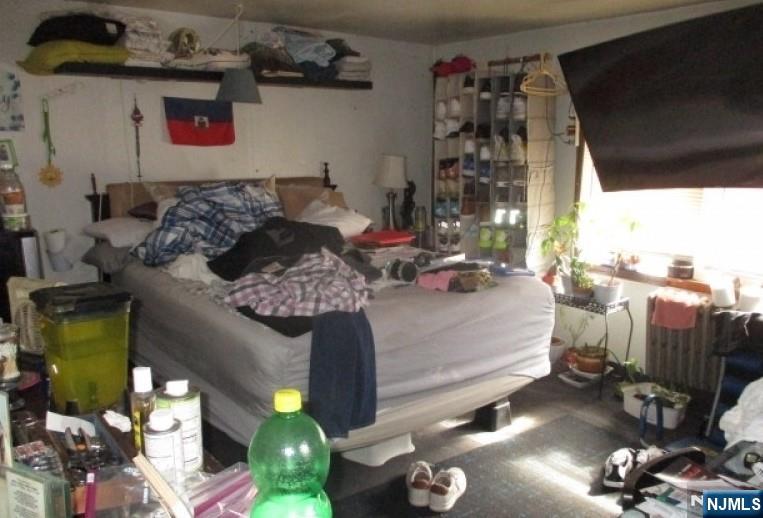 197 Fairmount Avenue Newark, NJ 07103 - Photo 8 of 10 a bedroom with bed and a bookshelf