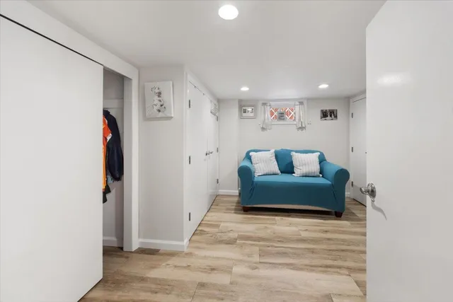 a living room with furniture and a walk in closet