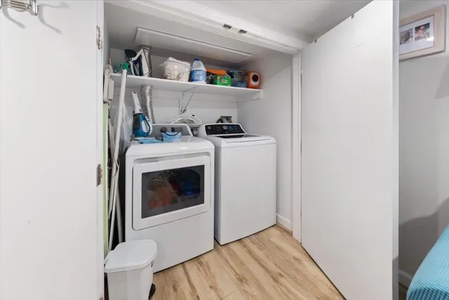 a view of washer and dryer with kitchen in the background