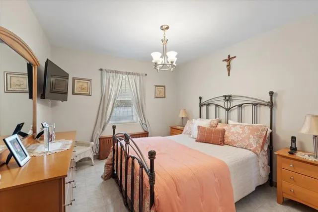 a bedroom with bed and window