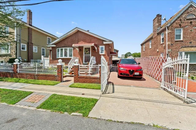 a front view of a house with a yard table and chairs