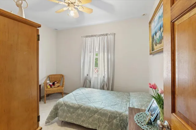 a bedroom with a bed and a window