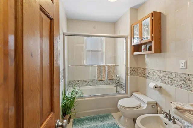 a bathroom with a toilet and a bathtub