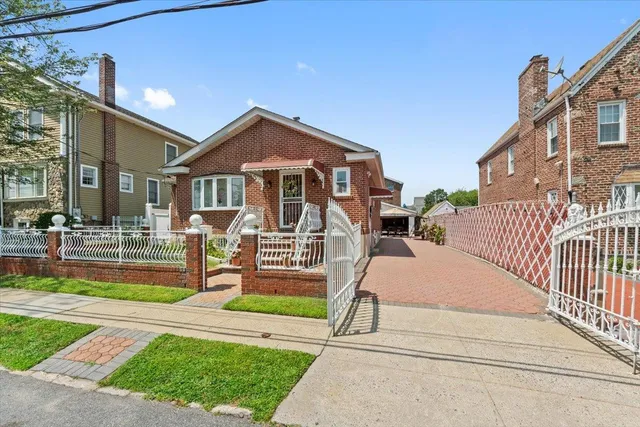 a front view of a house with a yard table and chairs
